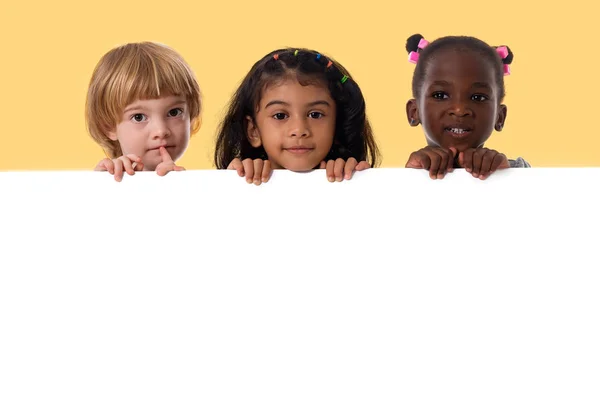 Group of multiracial kids portrait with white board — Stock Photo, Image