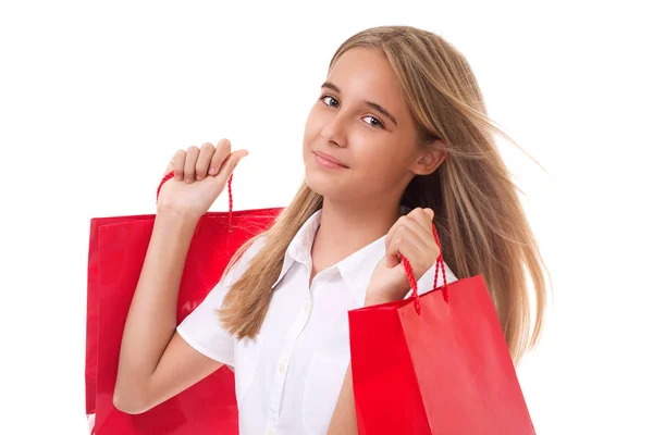 Happy teenage girl with red shopping bags. isolated — Stock Photo, Image