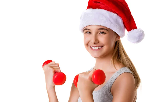 Γυμναστήριο κατάρτιση νεαρό κορίτσι Χριστούγεννα άρση χέρι βάρος φορώντας καπέλο Σάντα — Φωτογραφία Αρχείου