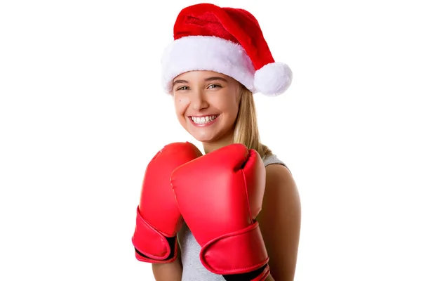 Sportig glad ung flicka klädd christmas santa hat med fighting handskar, isolerade — Stockfoto