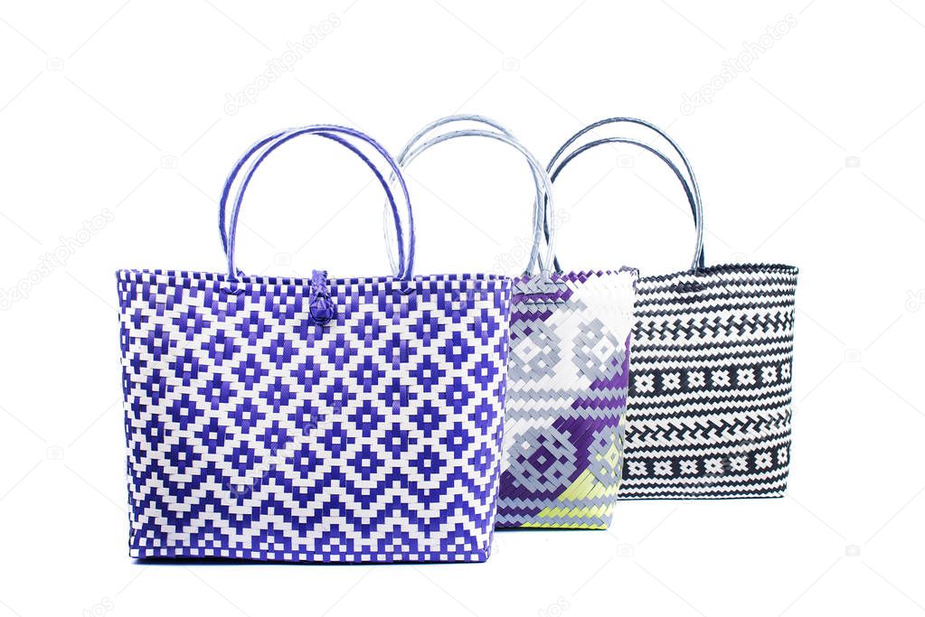 three wicker woman's tote bags, isolated on white background