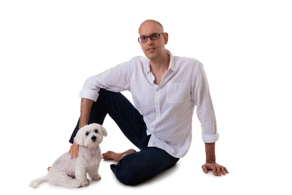 Portrait of man and maltese dog on the floor in studio, isolated — Stock Photo, Image