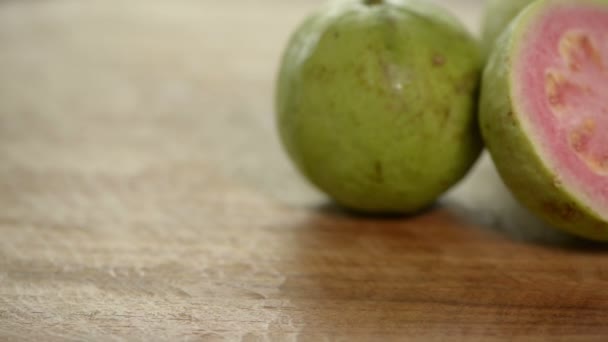Cut Pink Guava Rotates Wooden Table — Stock Video