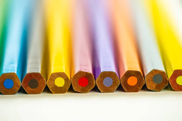 Végei színes ceruzák feküdnek egy könnyű háttér. — Stock Fotó
