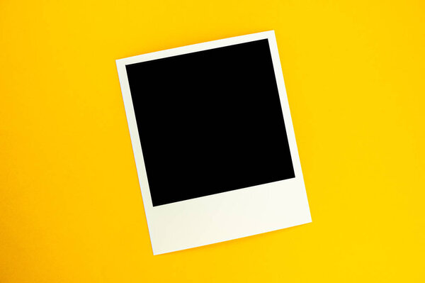 photo with the image of a black square lies on a yellow backgrou
