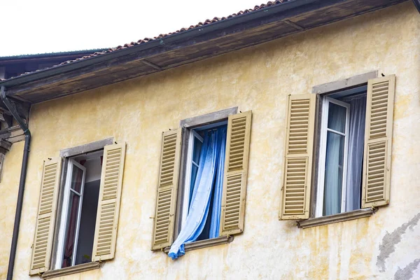 Italian house. Blue curtains in the window, Italian style architecture