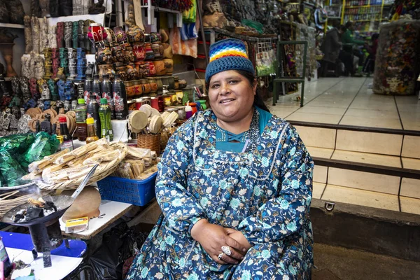 LA PAZ, BOLIVIA - January 2020: Bolivian woman wearing traditional dress (Cholitas) on the market in La Paz city, Bolivia. People of Bolivia. Traditional market in Bolivia.