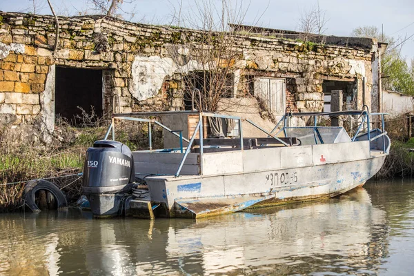 Fishing boat with fisherman on the water at Danube delta in Vilkovo, Ukraine