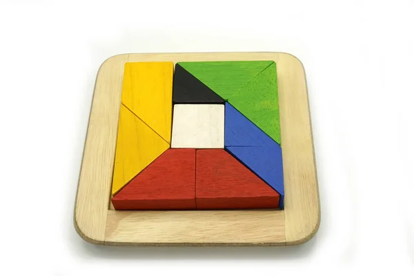 Tangram, kínai hagyományos puzzle játék készült különböző színes fa darabok, hogy jön össze egy külön formában, egy fadobozban. — Stock Fotó