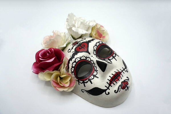 Sugar skull mask with flowers used for celebrating Day of the Dead in hispanic culture.