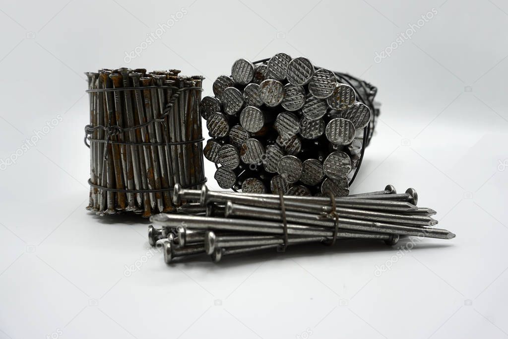 Steel construction nails of different lengths tied together in groups.