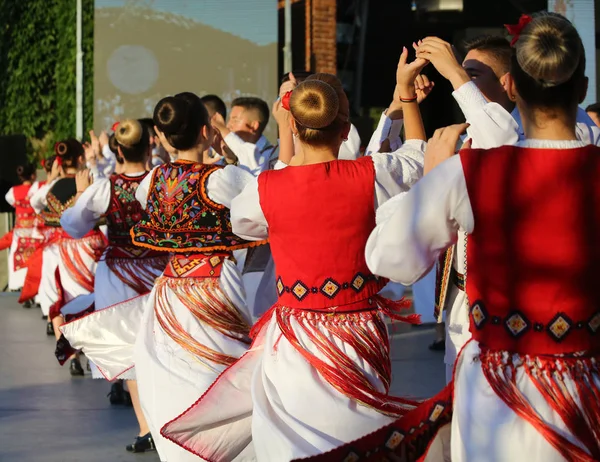 TIMISOARA, ROMANIE 07.04.2019 Les danseurs se tiennent la main dans une danse folklorique roumaine traditionnelle portant de beaux costumes traditionnels lors d'un festival gratuit dans le parc . — Photo