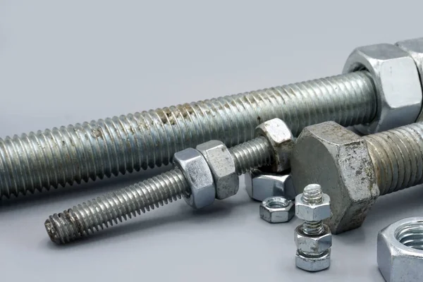 Stainless Steel Screws Nuts Isolated Gray Background New Shiny Chrome — 图库照片