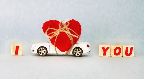 Machine carring a heart Valentines Day wooden cubes with the inscription