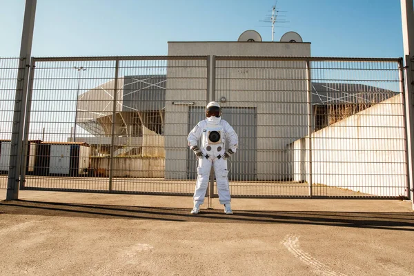 Astronaut on futuristic city background, glimpse at future. Fantastic Cosmic Costume.