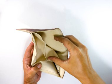 Elleri çantanın içinde ama cüzdanında para yok. Beyaz bir arkaplanda.