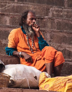 Varanasi, India - Dec 23, 2019: Sadhu at the ghats in Varanasi in India