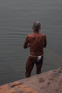 Varanasi, India - Dec 26, 2019: Hindu taking ritual bath in the river Ganga
