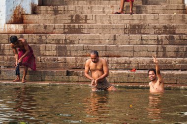 Varanasi, India - Dec 26, 2019: Hindu taking ritual bath in the river Ganga