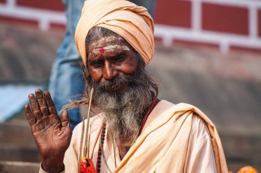 Varanasi, India - Dec 23, 2019: Sadhu at the ghats in Varanasi in India