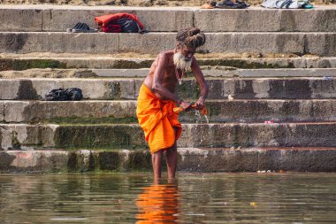 Varanasi, India - Dec 23, 2019: Sadhu at the ghats in Varanasi in India