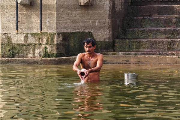Varanasi, India - Dec 26, 2019: Hindu taking ritual bath in the river Ganga