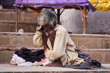 Varanasi, India - Dec 23, 2019: Sadhu at the ghats in Varanasi in India