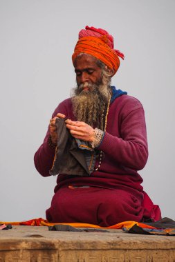 Varanasi, India - Dec 23, 2019: Sadhu at the ghats in Varanasi in India