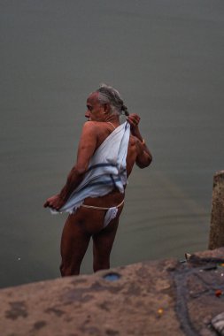 Varanasi, India - Dec 26, 2019: Hindu taking ritual bath in the river Ganga