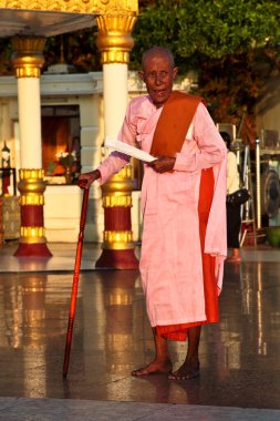 Kyaiktiyo, Myanmar - Nov 04, 2019: Woman at Kyaiktiyo Pagoda also known as Golden Rock is a well-known Buddhist pilgrimage site in Myanmar, Night view of Burmese pagoda, Golden rock, Balancing rock