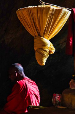 Hpa-an, Myanmar - Nov 06, 2019: Monk inside of Kaw Ka Thaung Cave, located close to Hpa-An, Myanmar