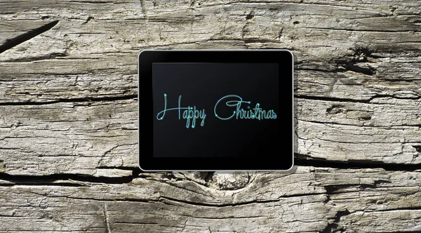 Vánoční pozdrav na dřevěném prkénku tabletu — Stock fotografie