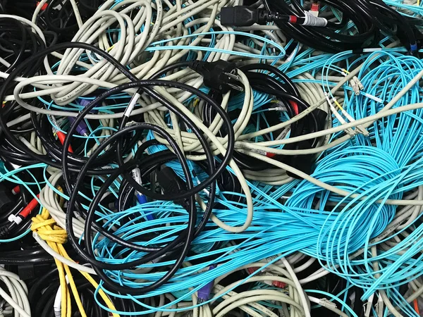 Old network cables and power cables in a pile for disposal