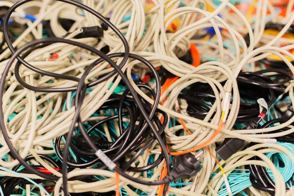 Old network cables and power cables in a pile for disposal