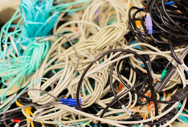 Old network cables and power cables in a pile for disposal