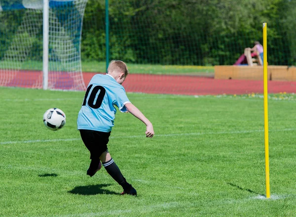 Jovem jogador de futebol no campo de futebol em ação — Fotografia de Stock