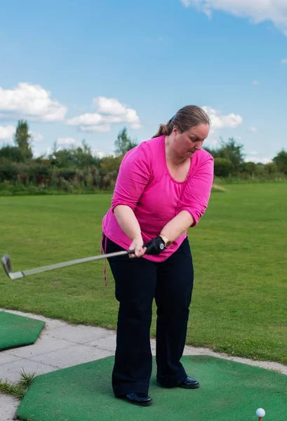 Golf player at tee off on a golf course