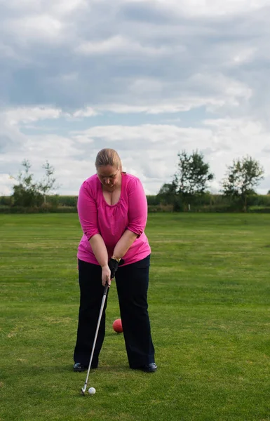 Golf player at tee off on a golf course