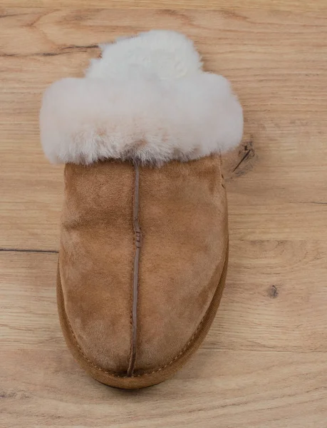 Fur Slippers Accessories on Wood Background in Flat Lay Still