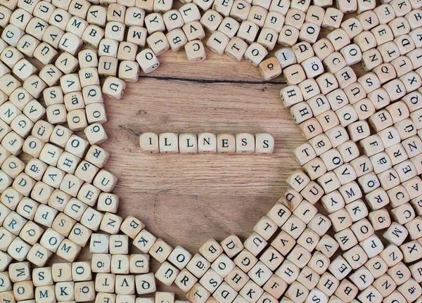 illness name in letters on cube dices on table