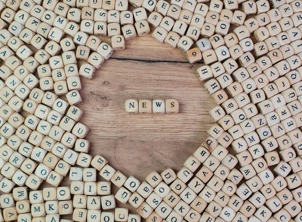 News name in letters on cube dices on table