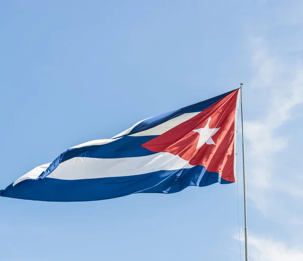 Cuba flag before blue sky and sunshine