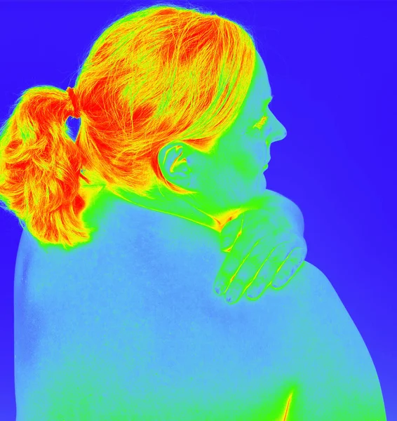 woman has neck pain and shows the pain point as a thermal image