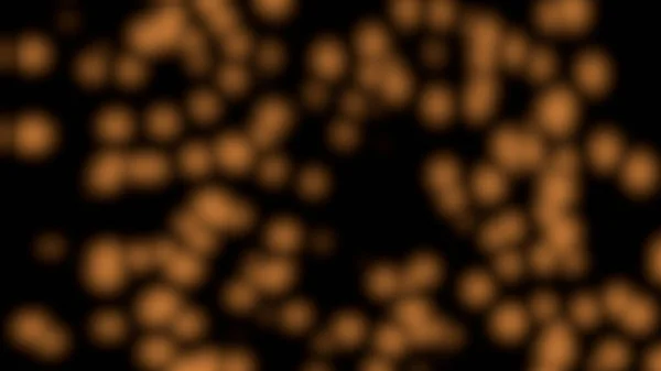 Random motion of particles of orange particles in bokeh over black background.