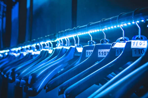 hangers hangers for clothes illuminated with neon tape hanging in a row