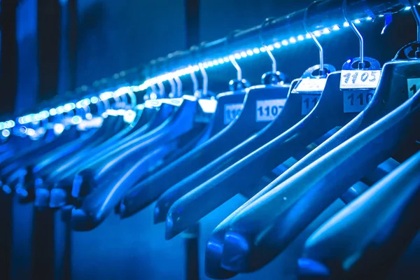 hangers hangers for clothes illuminated with neon tape hanging in a row