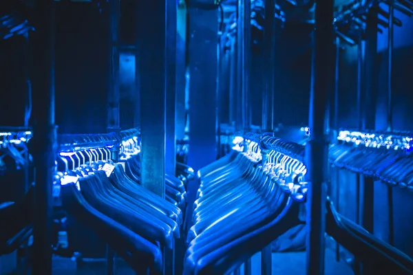 hangers hangers for clothes illuminated with neon tape hanging in a row