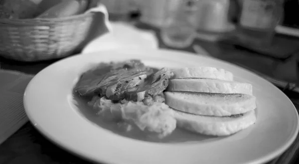 Meatloaf with sauerkraut in sauce and boiled potatoes in the form of roll — Stock Photo, Image