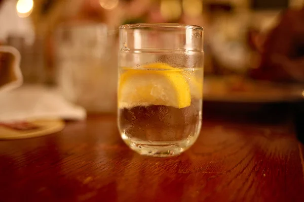 A glass of lemonade stands on a table in a restaurant — ストック写真