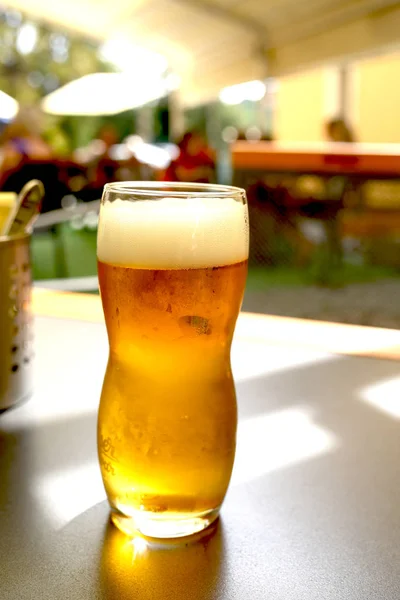 Taza de cerveza en una mesa de madera se encuentra en un pub — Foto de Stock